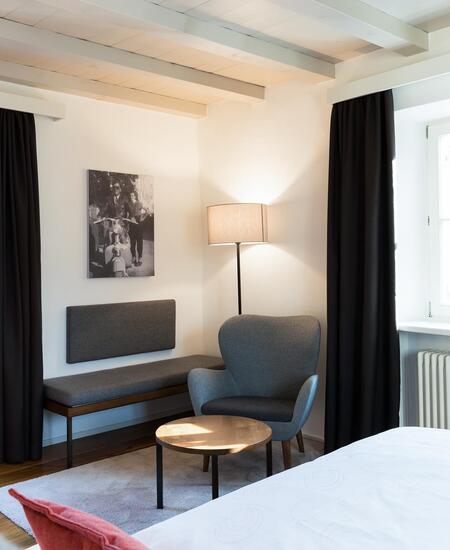 A room with double bed and sitting corner