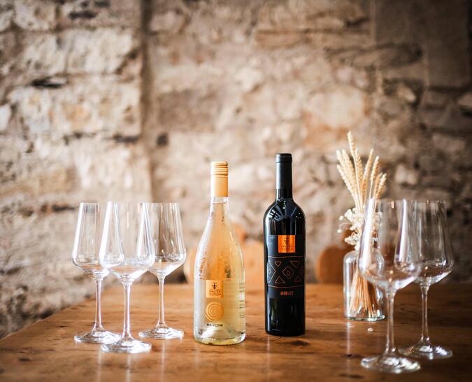 Bottles and glasses for the wine tasting in the wine cellar